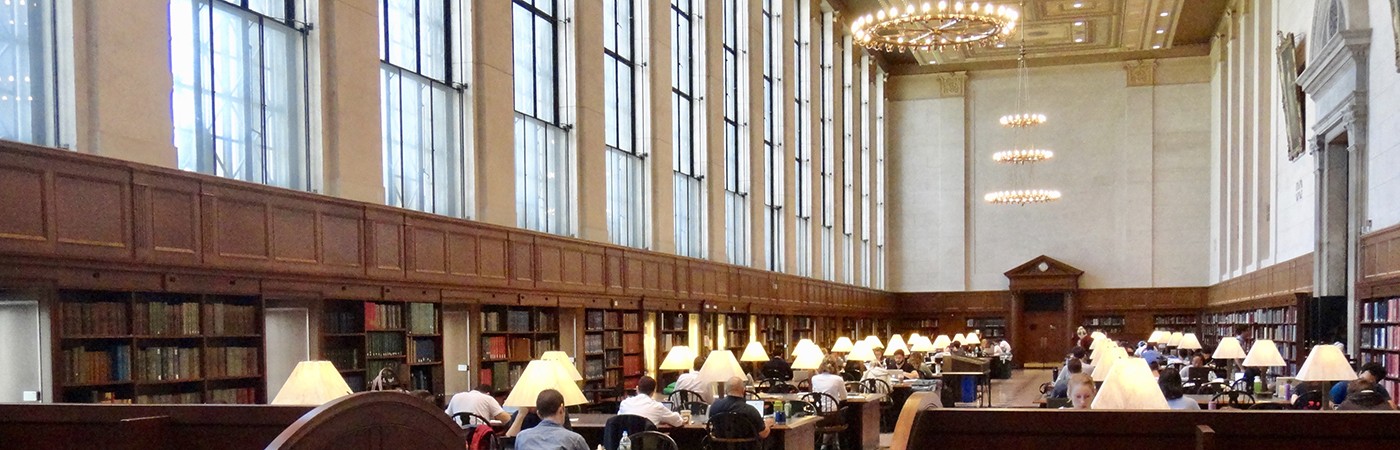 Students study and work at tables inside of Columbia University's Butler Library